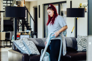 employee vacuuming living room