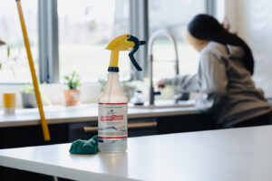 employee cleaning kitchen sink