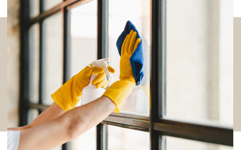 person cleaning a window